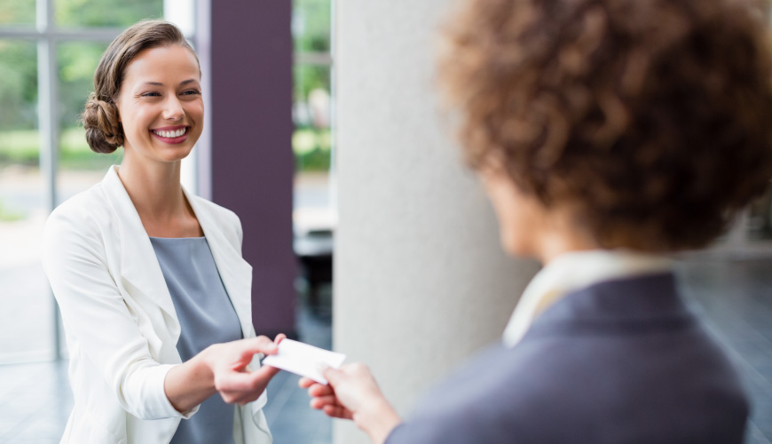 Women handing out business cards