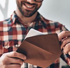 Man opening a printed invitation