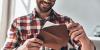 Man opening a printed invitation